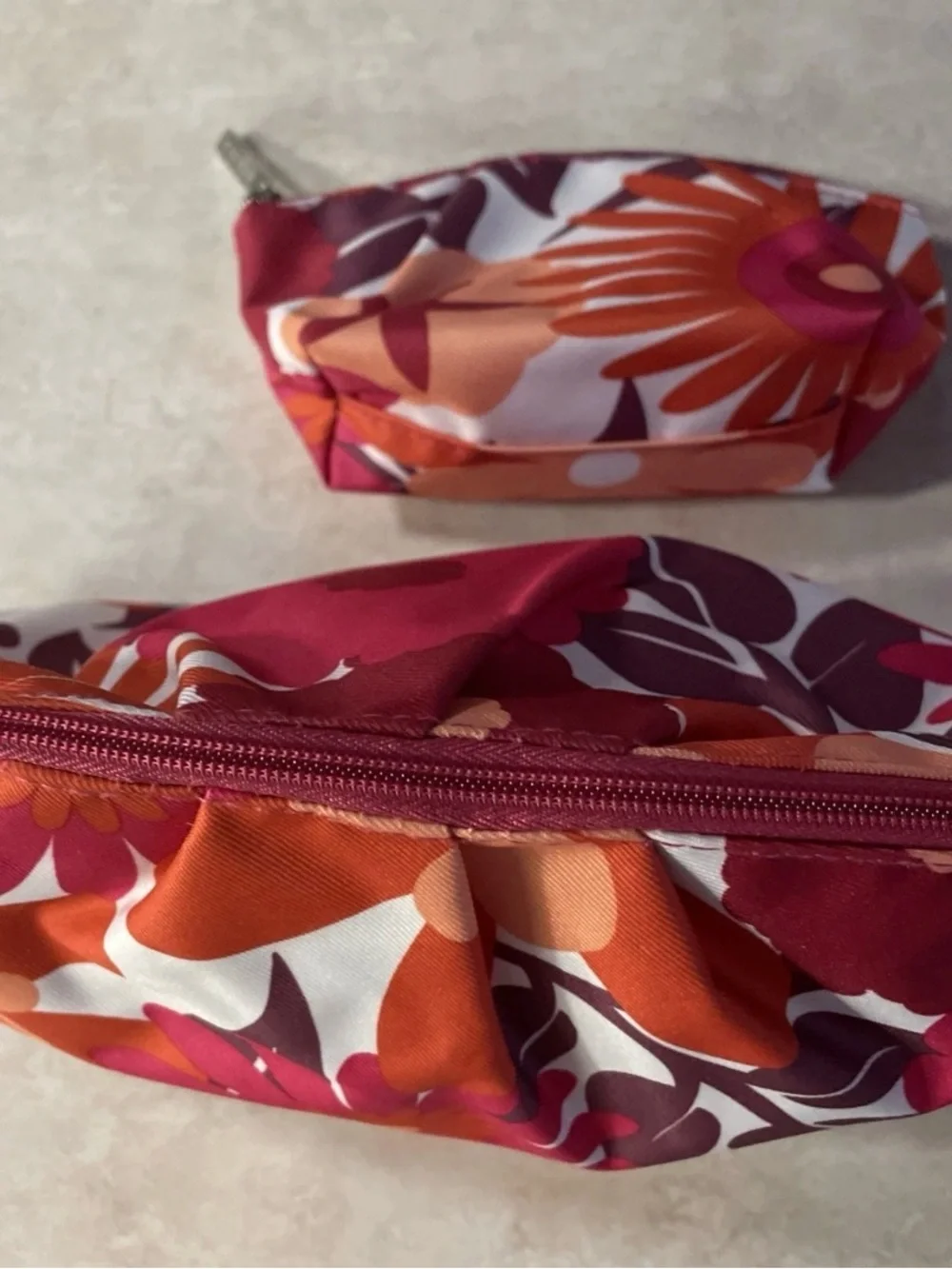 Clinique maroon, orange, pink, and white floral makeup bags #makeup #floral